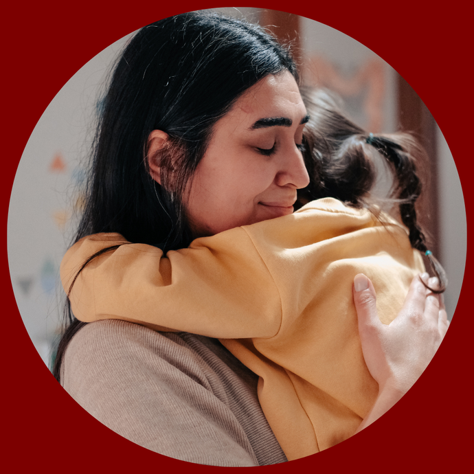 Parent hugging child closely, showing comfort and reassurance during separation